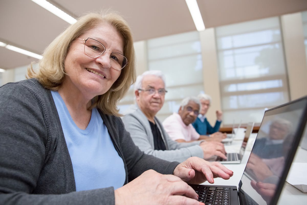 Adults learning computer and digital skills in a classroom